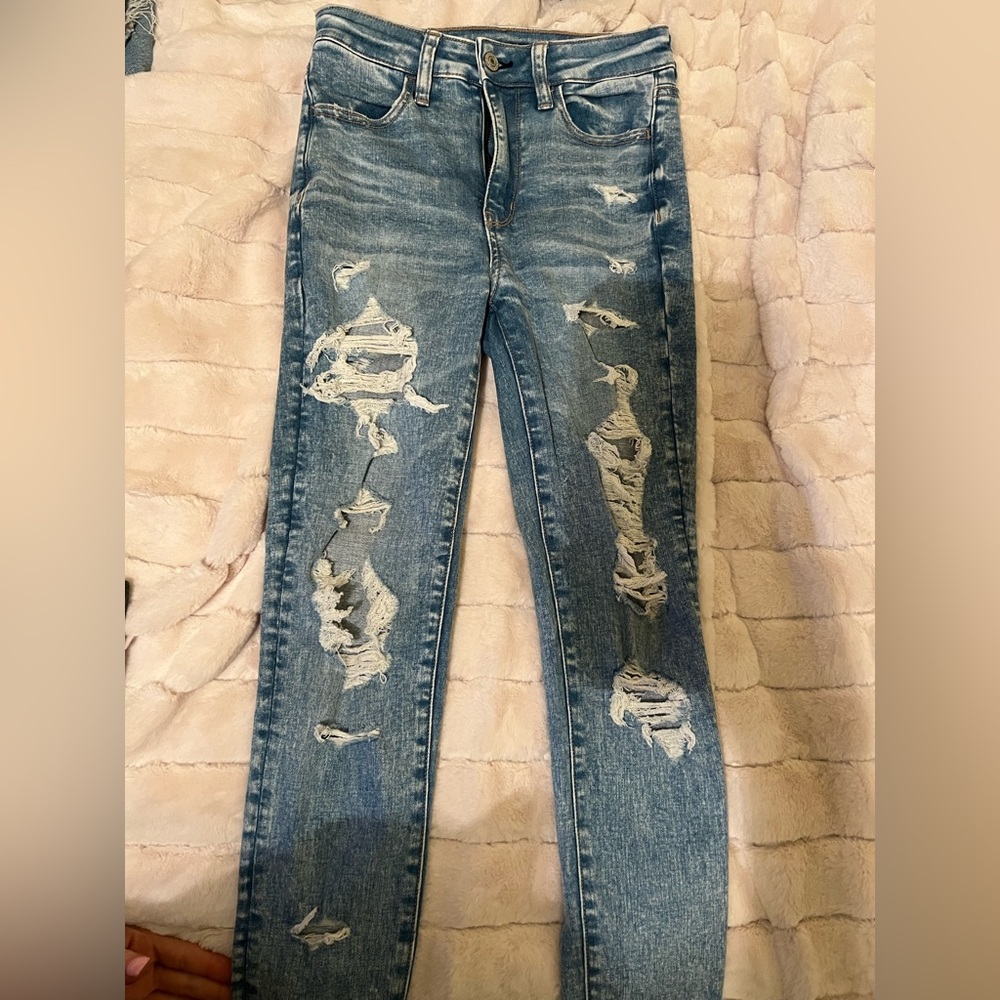 American Eagle. stretchy jeans…fashion cut holes throughout legs. Short cut.